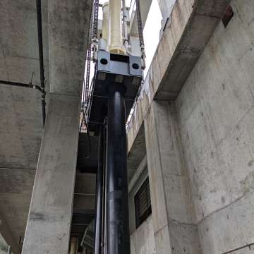 Set of large, long-stroke cylinders for hydroelectric dam outlet gate being installed.
