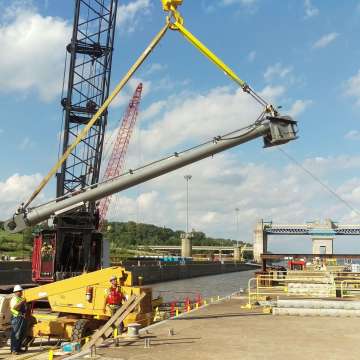 Long stroke hydraulic cylinder being lifted by a crane while being installed at a USACE navigational lock
