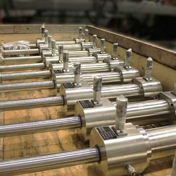 Custom subsea stainless steel, double rod hydraulic cylinders being prepared for shipment in a crate