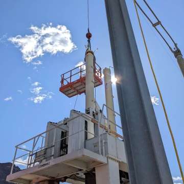 Two very long stroke hydraulic cylinders for a hydroelectric dam outlet gate being installed