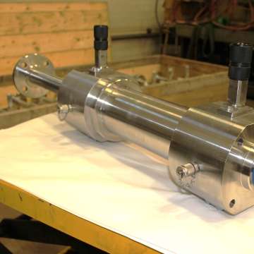 Custom engineered 316 stainless steel hydraulic cylinder with hollow double rod and end-of-stroke proximity switches