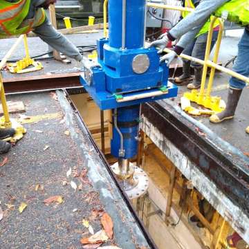 Custom engineered Stoney gate hoist hydraulic cylinder being lowered into machinery room